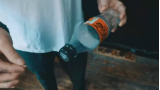 Slo Mo Coin in Bottle by Lloyd Barnes